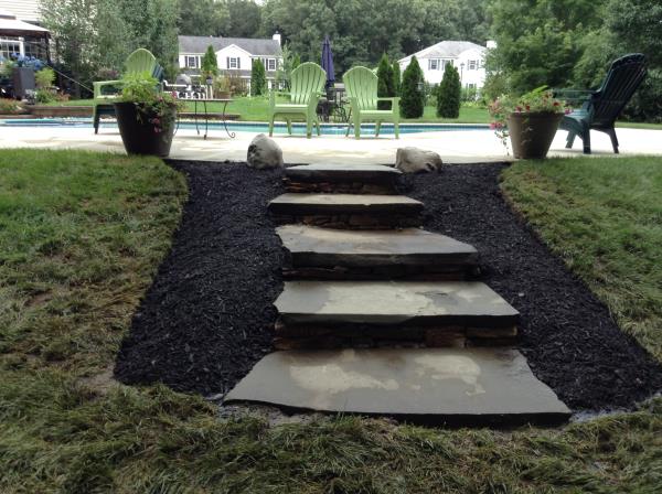 These photos are from the design and build of a boulder retaing wall and steps