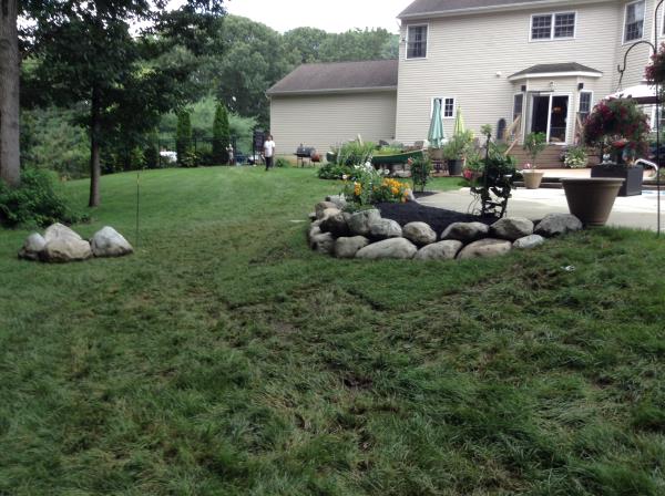 These photos are from the design and build of a boulder retaing wall and steps