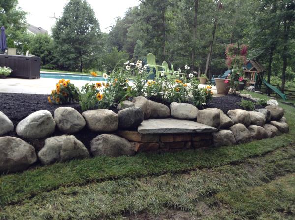 These photos are from the design and build of a boulder retaing wall and steps