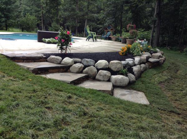 These photos are from the design and build of a boulder retaing wall and steps